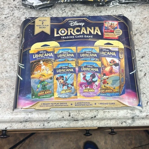 Disney Lorcana Gift Set with Black and Gold Tote and stitch figural bag clips.